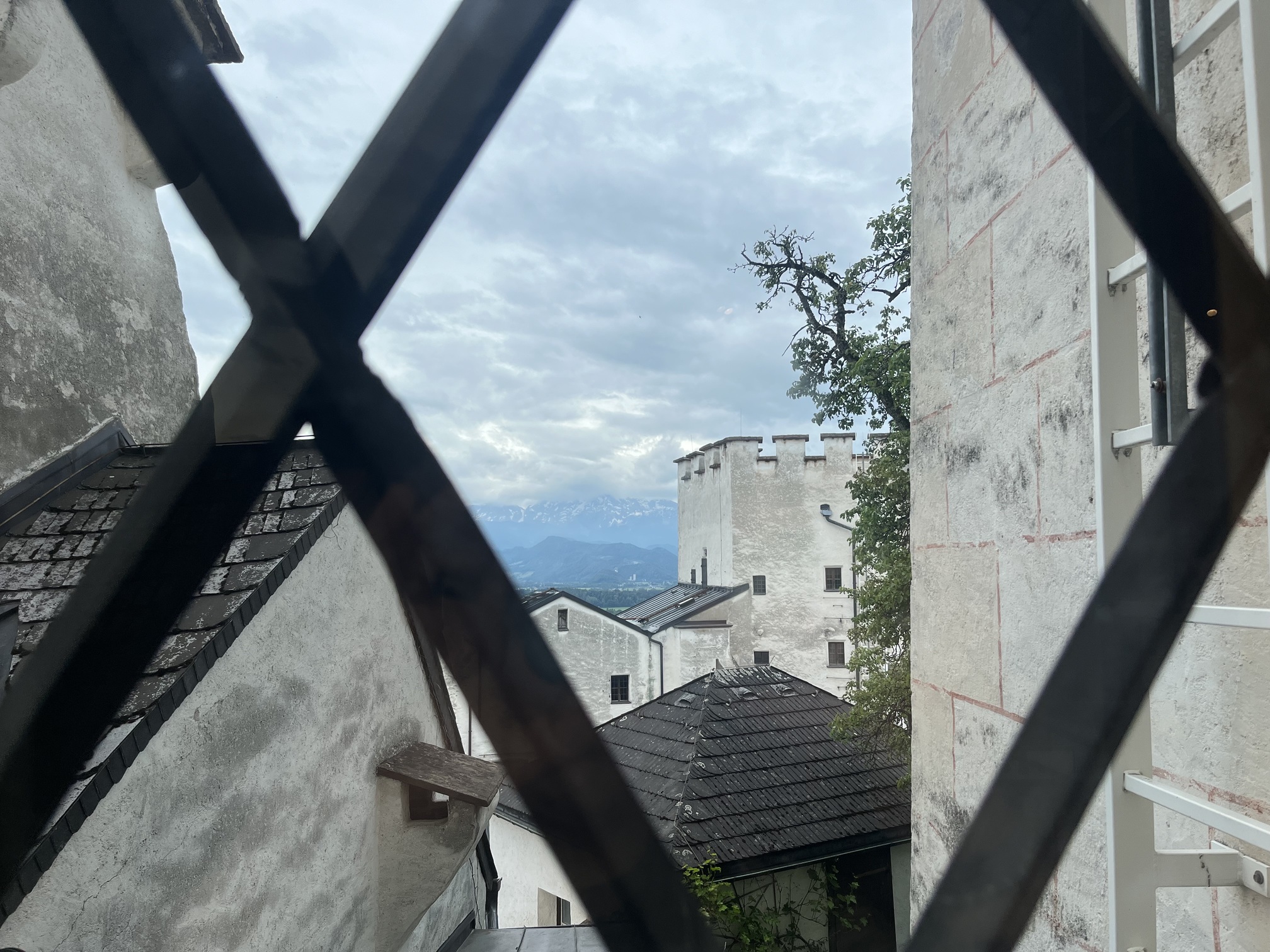 An image looking through a zig-zagged window with seemingly Italian style architecture. 