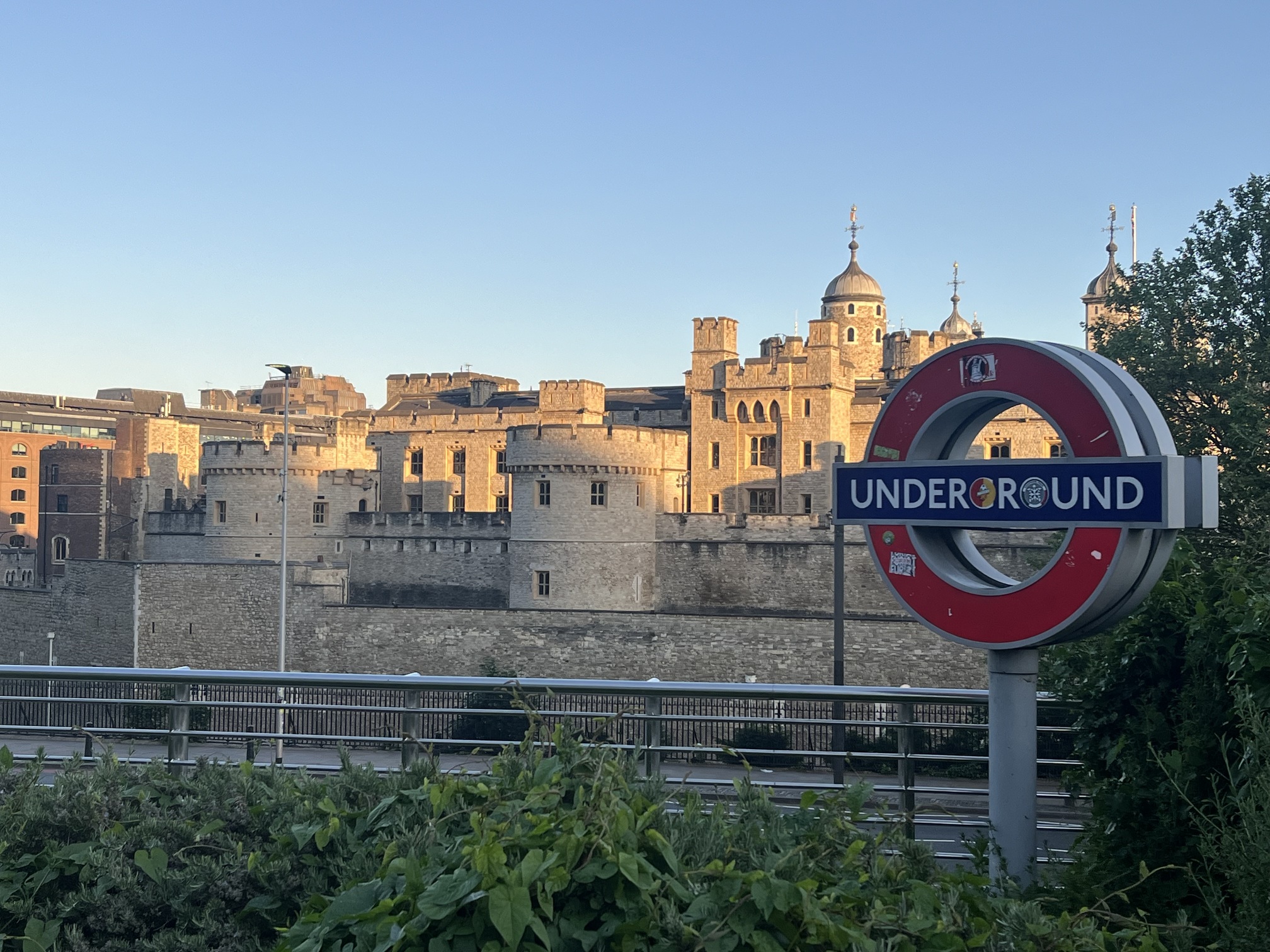 Photograph with circular sign on the right reading "Underground"; stone castle-like architecture in the background. 